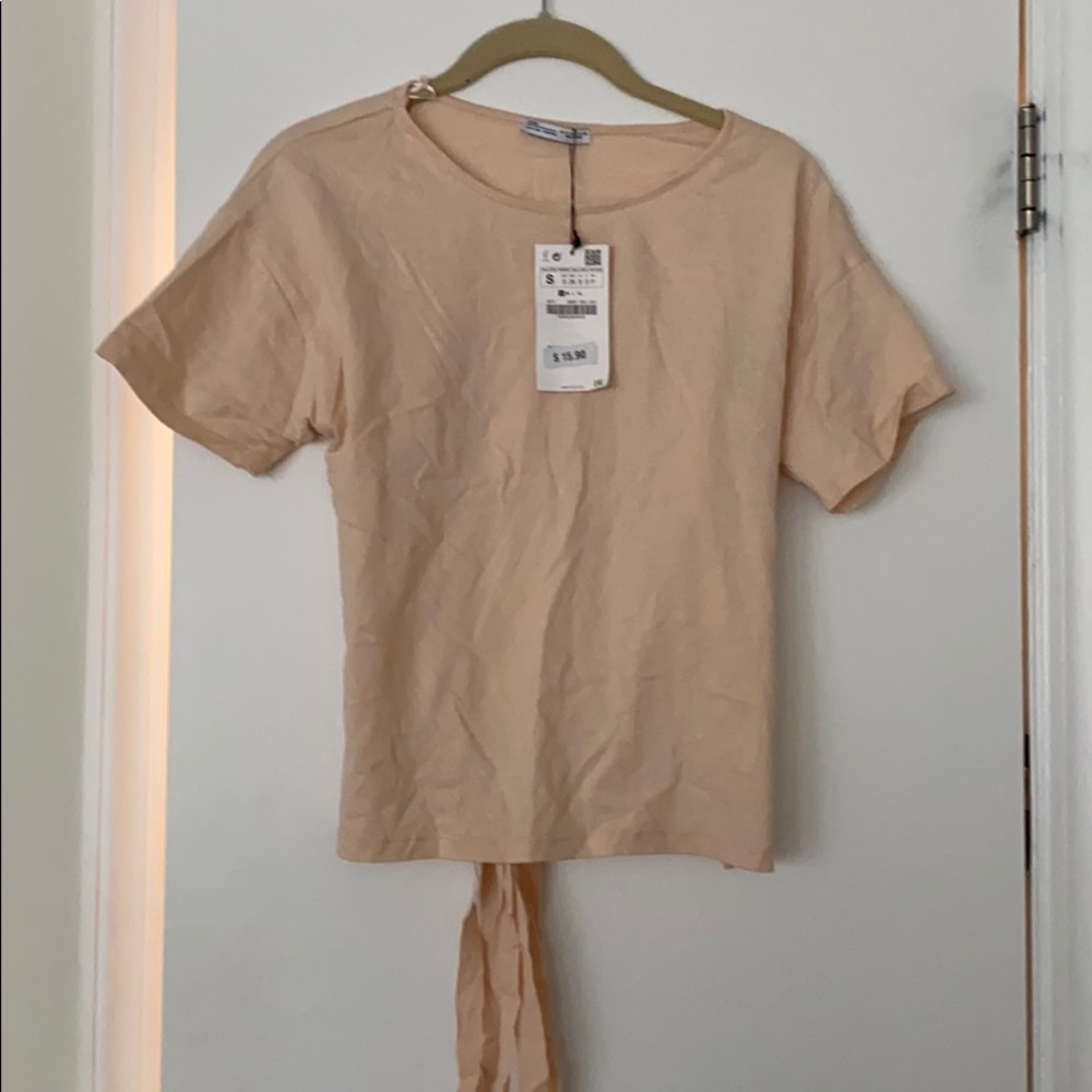 Peach colored tee with open back and ties